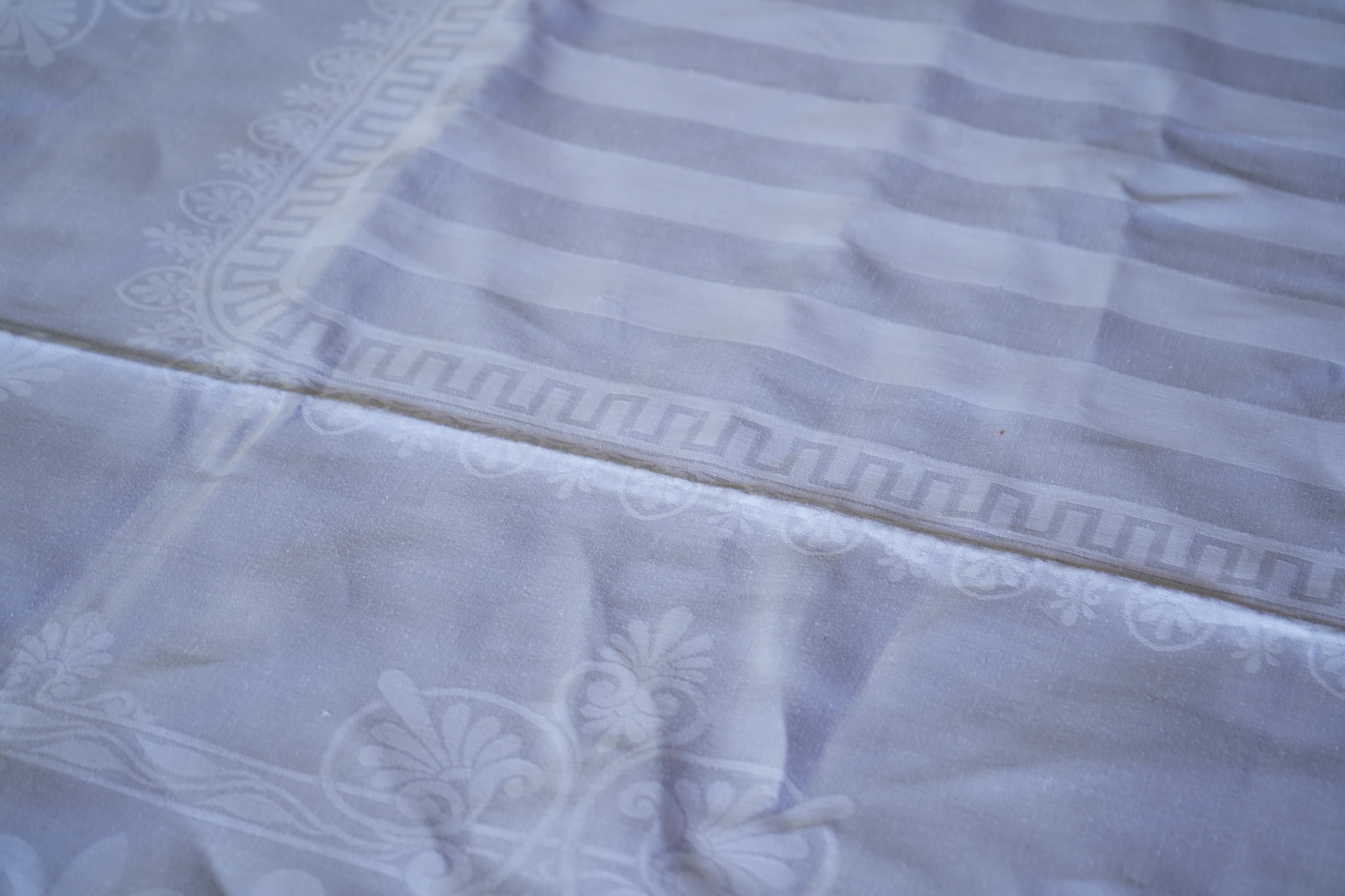 A late 19th century large white Irish damask table cloth, woven with an all over Christopher Dresser ‘inspired’ design. The overall design incorporating many of his known stylistic design motifs. Each corner has a shamro